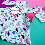 Dinosaur clothes for girls Tyrannosaurus rex dinosaurs twirl dress with pockets girl clothing twirly pocket dresses science stem paleontology girly pink purple kids pants toddler shirt t-shirt birthday dino party theme gift baby children’s child infant nerd geek nerdy geeky ethical fashion brand style scientist smart smarty pima cotton Peru outfit apparel Kansas company mom-owned circle skirt ballet t-rex skater