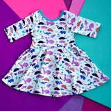 Dinosaur clothes for girls dinosaurs twirl dress with pockets girl clothing twirly pocket dresses science stem paleontology girly pink purple kids pants toddler shirt t-shirt birthday dino party theme gift baby children’s child infant nerd geek nerdy geeky ethical fashion brand style scientist smart smarty pima cotton Peru outfit apparel Kansas company mom-owned circle skirt ballet flat lay photography colorful skater